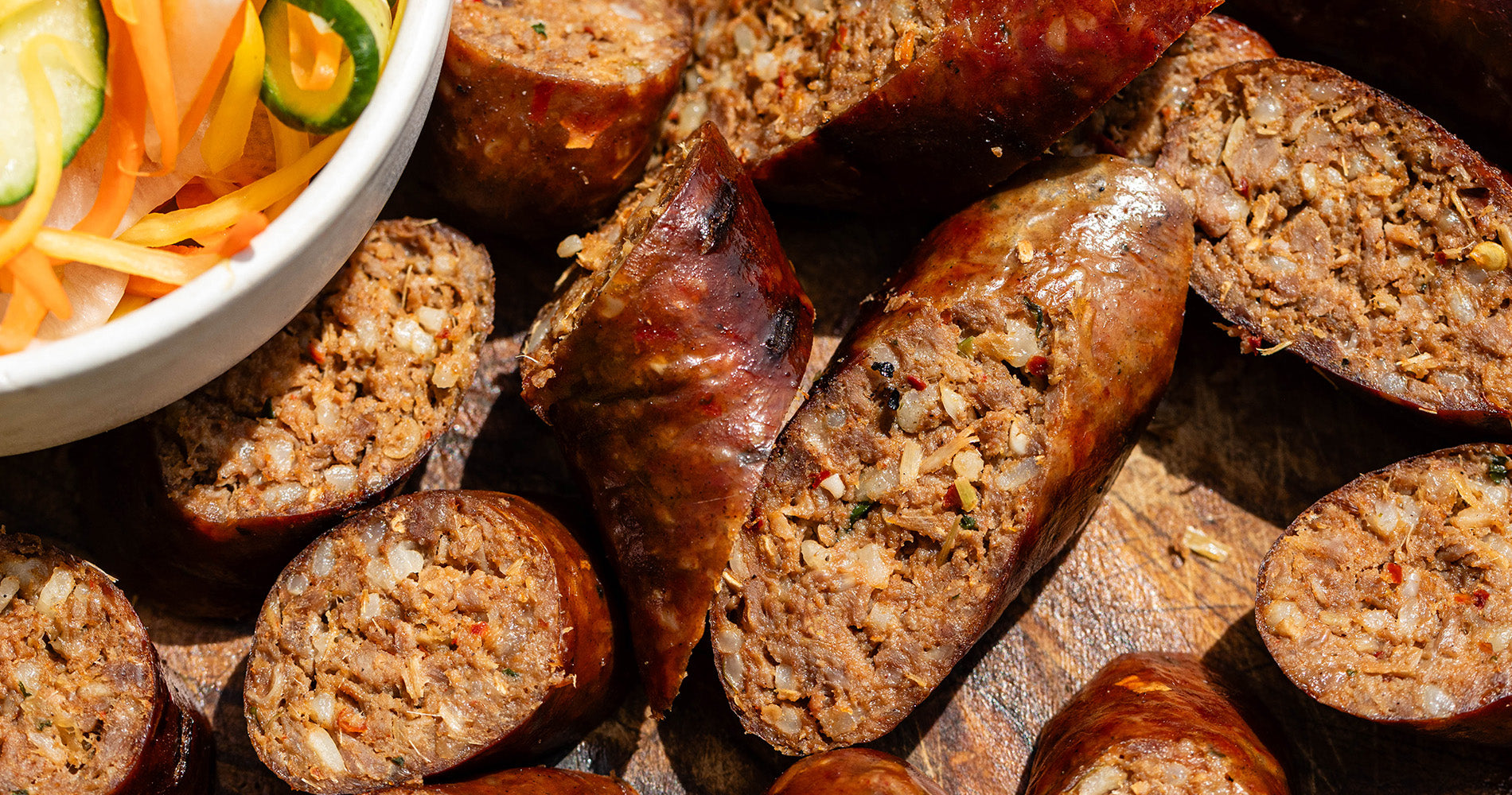 classic Cumberland sausage slowly cooked in a frying pan and the collection highlight for sausages & sausagemeat