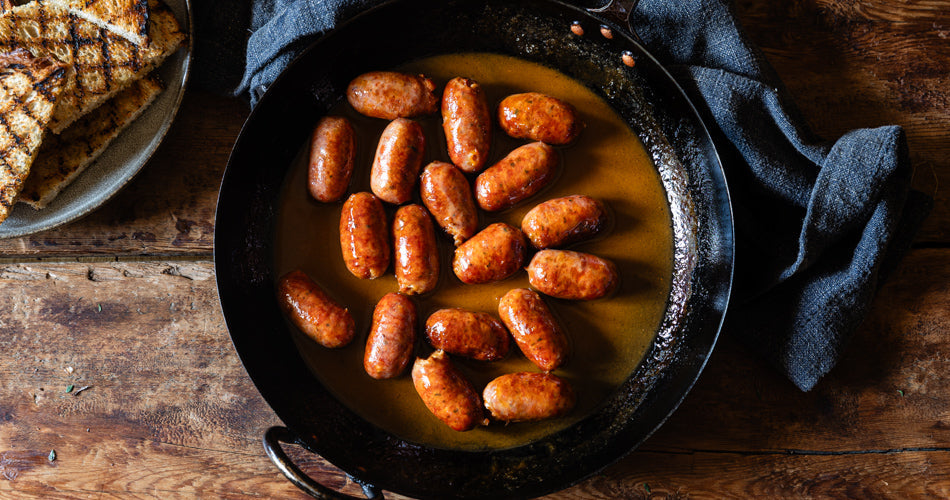 classic Cumberland sausage slowly cooked in a frying pan and the collection highlight for sausages & sausagemeat