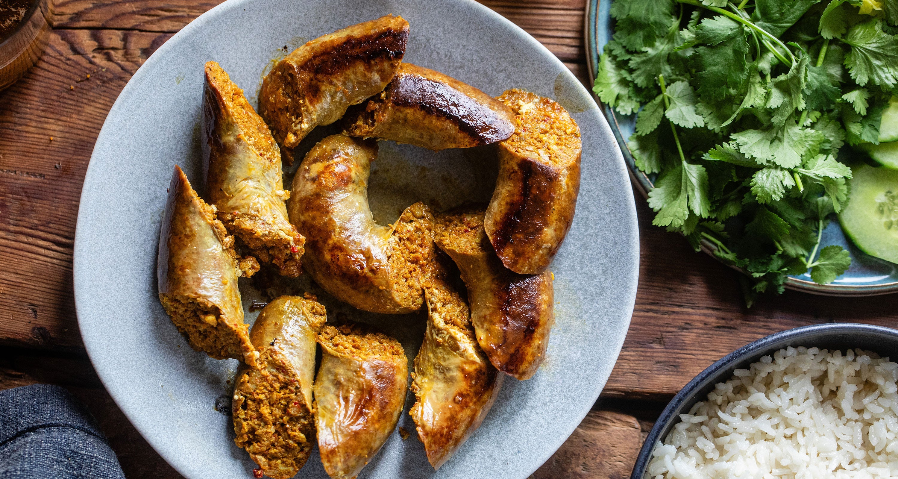 classic Cumberland sausage slowly cooked in a frying pan and the collection highlight for sausages & sausagemeat