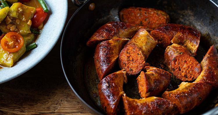 classic Cumberland sausage slowly cooked in a frying pan and the collection highlight for sausages & sausagemeat