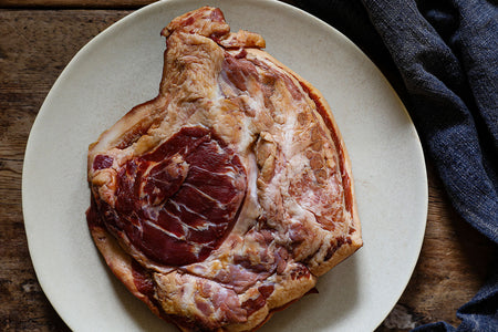 a whole (raw) pig's ear photographed from both sides. One pig's ear is approx. the size of a human hand with fingers outstretched. Swaledale Online Butchers only sell outdoor reared, heritage-bred pork from The Dales 