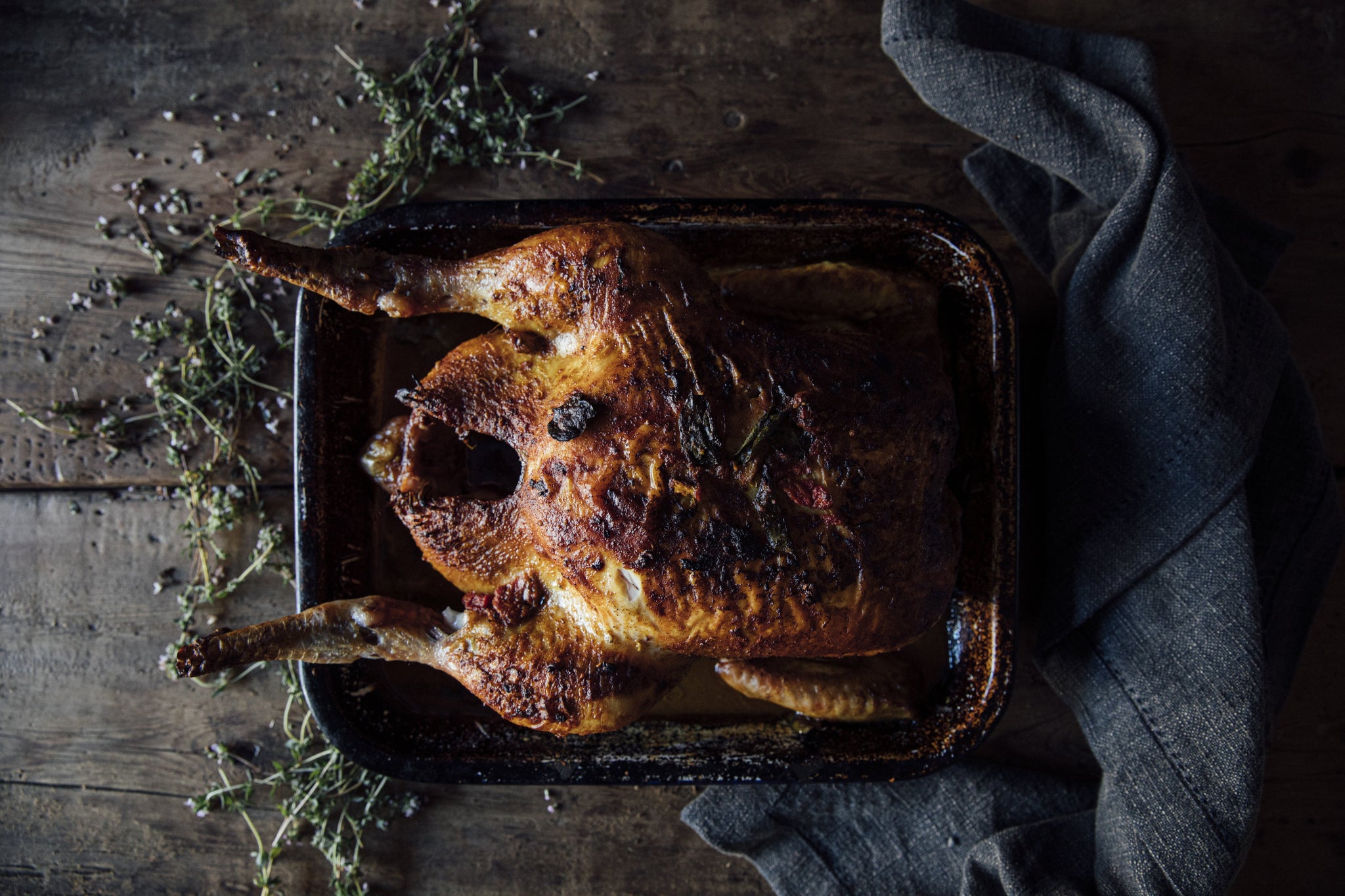 a herb-fed, free range chicken that has been roasted and is ready to carve