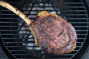 grass-fed, dry-aged tomahawk steak almost cooked on the bbq 
